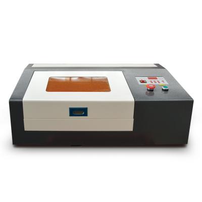 China Laser Engraving 50W Mini Laser Cutting Machine 3020 CO2 Laser Engraving Machine for Acrylic Plastic Wood Cork for sale