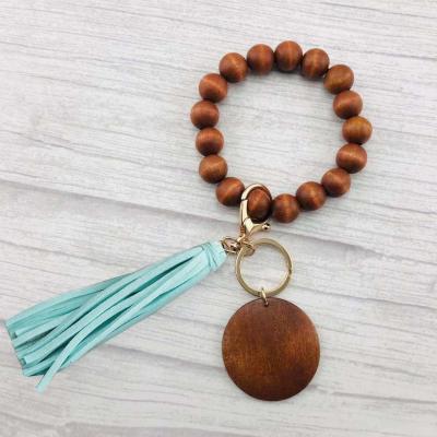 China Fanshion Monogram Bracelet Key Ring With Tassel Wooden Beads Fringed Key Chain for sale