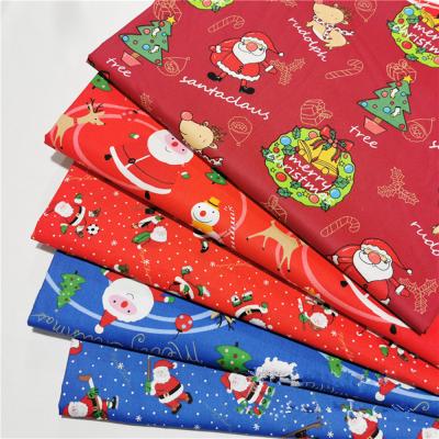 China Red Blue Santa Claus Twill Cotton Cartoon Fabric Shrink-Resistant Making Bedding Apparel Christmas Handmade Fabric for sale