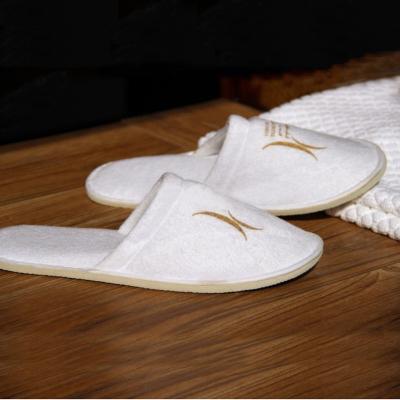 China Eco-friendly Solt Ect. Wholesale Cheap Soft Hotel Bedroom Custom Logo Slippers for Hotels and Resorts for sale