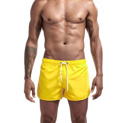 China Custom Logo Summer Solid Color Athletic Anti-Wrinkle Quick Dry Shorts Beach Abbreviations Men for sale