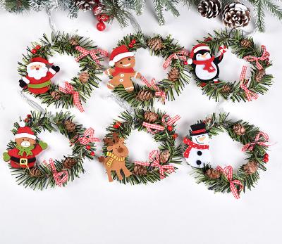 China 2022 Hotselling Eco-friendly Christmas Decorations Christmas Wreath Santa Claus Elk Round Pendant PVC Ornament Christmas Tree Pine Cone Pendant for sale