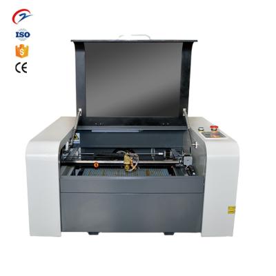 China Large size 6040 CO2 100w CO2 laser cutting machine water cooled galvo laser marking machine big price for sale