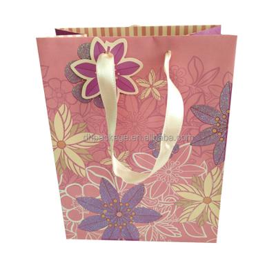 China Recycled Materials Wholesale Custom Size Printed Design Glitter Flower Paper Bag With Ribbon for sale