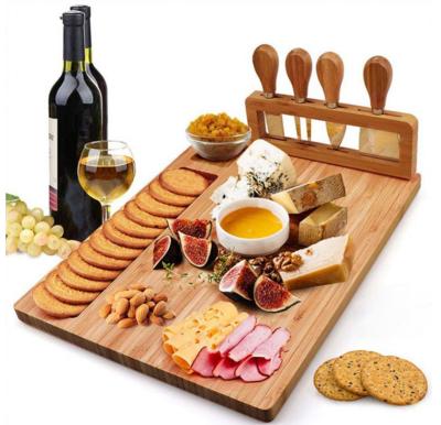 China Amazon Sustainable Hot Custom Wooden Bamboo Cheese Board Set With Cutlery In Slide Out Drawer Cheese Tray Cutting Board for sale