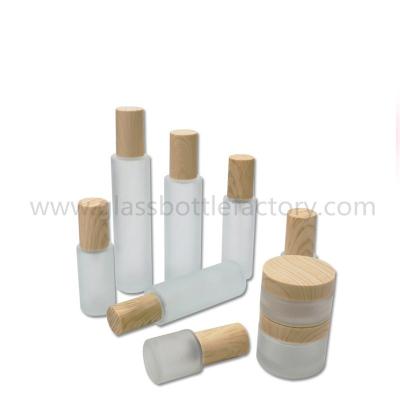 China Hot Items Frost Cylinder Glass Lotion Bottles With Wood Cap & Glass Cosmetic Jars With Wood Cap for sale