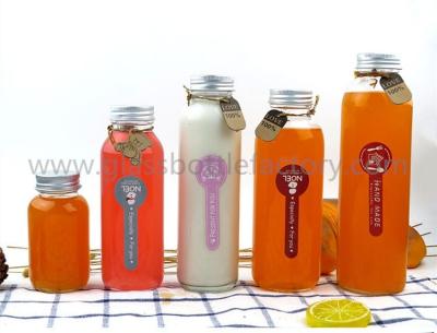 China 150ml,300ml,350ml,400ml,500ml New Items Clear Glass Juice Bottles With Silver Caps for sale