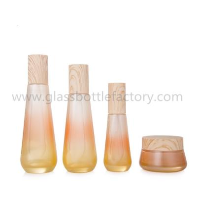 China New Items 40ml,100ml,120ml,50g Colored Glass Lotion Bottles And Cosmetic Jars With Wood Caps For Skincare for sale