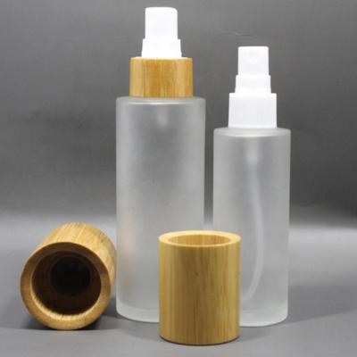 China Eco-Friendly Personal Care Products Cosmetic Packaging 50ml 100ml Frosted Lotion Bottle Glass Natural Bamboo Cover for sale