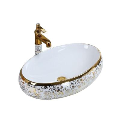 China Scandinavian Elegant European Oval Gold Table Basin Hotel Porcelain Hotel White Ceramic Luxury Gold Over Counter Sink 60x40cm for sale