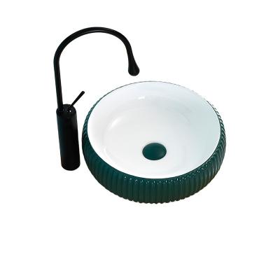 China 2022 Hot Selling Minimalist Ceramic Small Bathroom Sink Nordic Green Round Over Counter Basin Carved Art Sink for sale