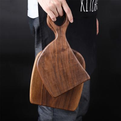 China Sustainable Household Kitchen Black Walnut Beech Couple Solid Wood Irregular Cutting Board Set With Handle for sale