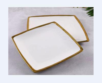 China Sustainable Modern Ceramic Irregular Rim White Porcelain Dishes Restaurant Gold Plate Hotel Used Charger Dishes for sale