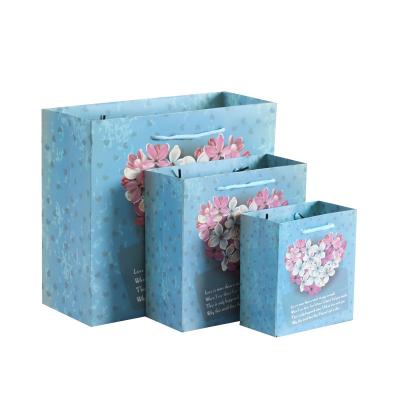 China Materials love flower paper bag candy gift bag creative blue creative portable gift bag for sale