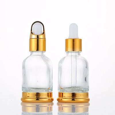 China Wholesale Personal Care 30ml 50ml Pearfum Glass Clear Gold Cosmetic Bottles Essential Oil Bottles With Dropper for sale