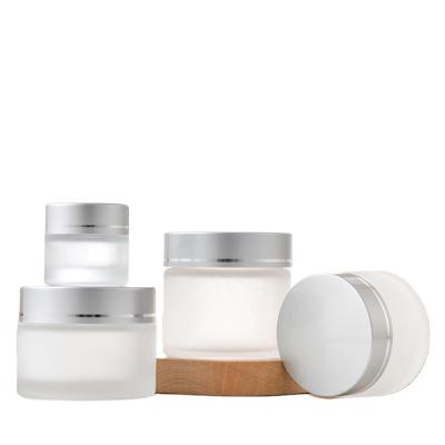 China Cosmetic in stock glass bottle for female skin face cream jars frosted cosmetic cream jar for sale