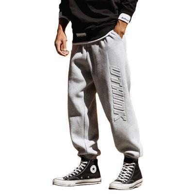 China custom Anti-wrinkle plain drawstring 3d embossed logo fleece sweatpants joggers baggy loose sport tracksuit for men for sale