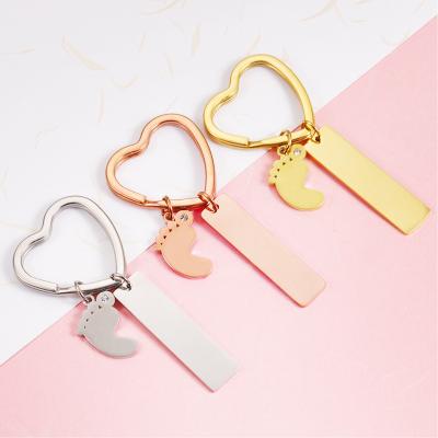 China New Environmental Friendly Stainless Steel Gold Plated White Custom Logo Name Feet Rectangle Key Chains for sale