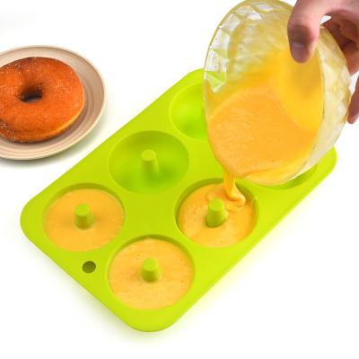 China Sustainable Kitchen Accessories 6 Cavity Heat Resistant Baking Pan Round Shape Silicone Donut Muffin Mold for sale