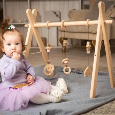 China Toy Winning Wholesales Natural Beech Educational Wooden Frame Foldable Baby Gym Wooden Play Gym Activity Center for sale