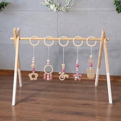 China Eco-Friendly Wooden Frame Stroller Beech Frame Gym Activity Baby Hanging Toys Teether Ring Nursing Rattle Toys Room Hanging Decor for sale