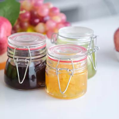 China Popular Wholesale 100ml 180ml 280ml Food Grade Round Honey Glass Jar With Clip Cover for sale