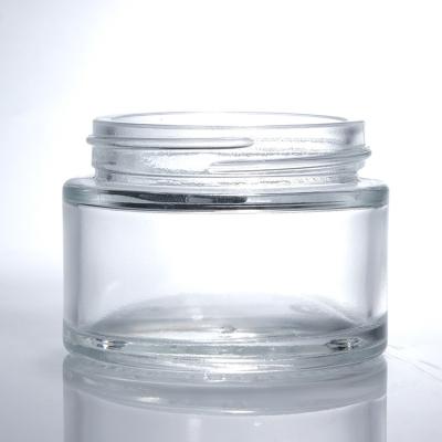 China Luxury Glass Cream Jars Transparent Round With Lid Skincare Face Cream Cosmetic Packaging for sale