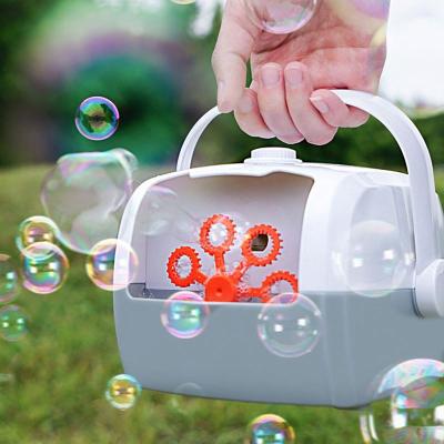 China Plastic Electric Bubble Machine Portable Automatic Bubble Making Machine Suitcase Model Summer Outdoor Toys For Kids Without Soap Water for sale