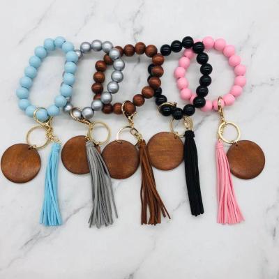 China Vintage Fast Delivery Time Wooden Beads Bracelet With Tassel Accept Custom Logo Engraved Charm Keychain Bracelet Trendy Bracelet for sale