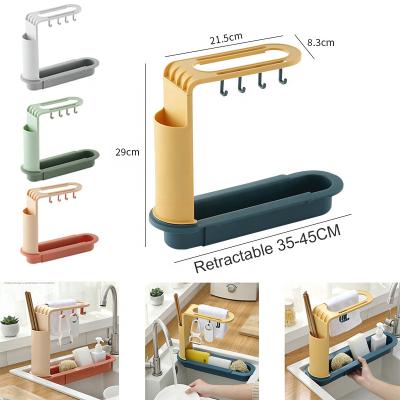 China Stocked Hot-selling kitchen sink racks plastic non-perforated retractable drain rack sponge storage rack with wand holder for sale