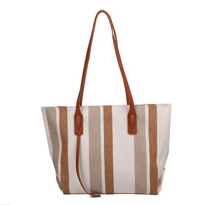 China Fashion Korean version large capacity women's shoulder bag, women's 2021 new simple vertical stripe casual tote bag, fashionable handbag for sale