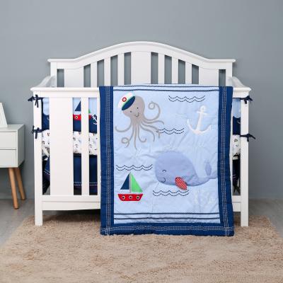 China Hot Sale OEKO-TEX 4pcs Disposable Crib Bedding Sets Blue Sea and Whale Design for Boys New Embroidery Design for sale