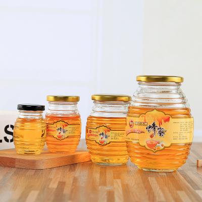 China Freshness Preservation Wholesale  lower price  different sizes glass bottle for honey/biscuit/jam packing  with spiral pattern and lid for sale