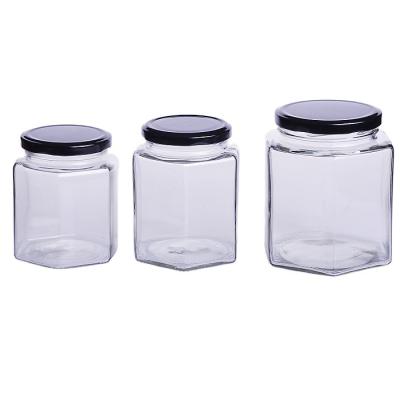 China Freshness Preservation manufactured clear smooth hexagon glass storage jar with lids used for frutta honey jam pickles for sale