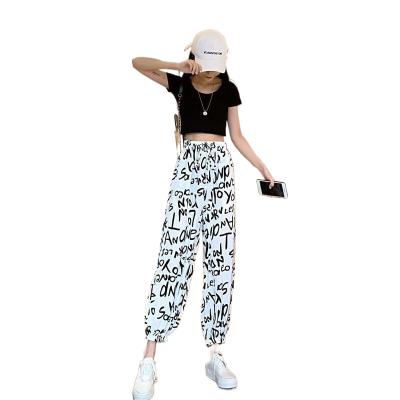 China Breathable Chiffon Bloomers Letters Graffiti Elastic Waist Tappered Sports And Leisure Printed Loose Pants for sale