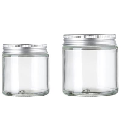 China Wholesale Cosmetic Cylinder 100g Transparent Glass Jar Handle Cosmetic Jars With Lid for sale