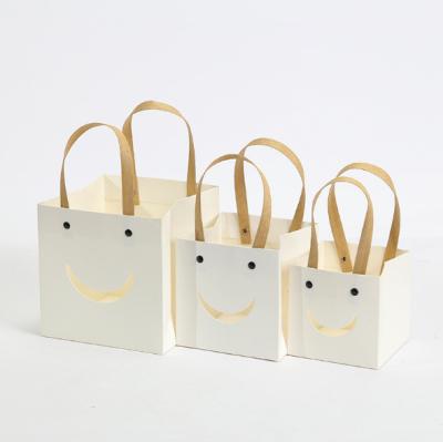 China For Birthday Smile Cavity Bag Feature Christmas Gift Bag Craft Strong Wrapping Craft Shopping Paper Bags With Handle for sale