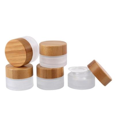 China Low Price New Typeface Cosmetic Packaging Glass Lid Frosted Body Cream Bamboo Bottle for sale