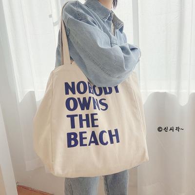 China Fashion Design Letter Printing Large Capacity Shoulder Beach Bag Black Cotton Eco-friendly Shopping White Canvas Tote Bag for sale