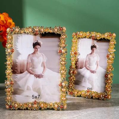 China Alloy European light luxury gold pearl photo frame 6/7/10 photo frame Bedroom decorations creative retro decorative photo frame for sale