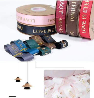 China Wholesale smooth gift wrapping ribbon rose gold printed grosgrain ribbon band with LOVE IS EVERLASTING for sale