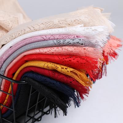 China Wholesale Newest Scarf Solid Color Tassel Hanging Scarf Breathable Hollow Shawl Lace Muslim Soft Headscarf for sale