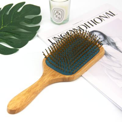 China Hot Selling Cushion Massage Detangling Paddle Brush Eco-frienly Wooden Paddle Hair Brush With Round Bristle for sale