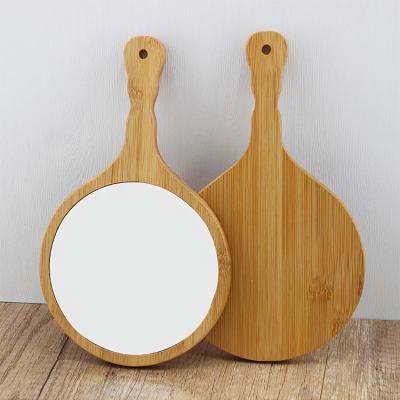 China Custom factory price customized logo eco-friendly bamboo hand around mirror glass makeup mirror for sale