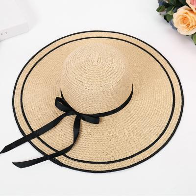 China Selling Lady Broad Brim Beach Bowknot Hat Ribbon Bowknot Hat Summer Comfy Sun Hat Natural Straw Hat Fashionable Foldable Soft Disc for sale