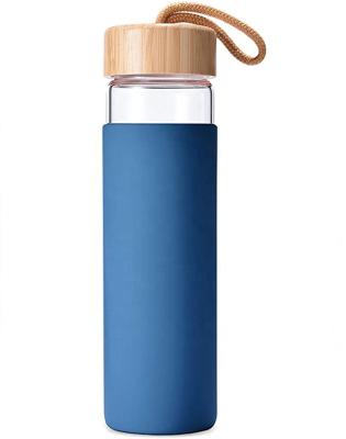 China Custom logo 500ml bpa free sustainable bamboo lid glass drinking water bottle with silicone sleeve for sale