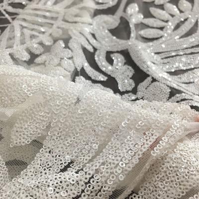 China Newest Heavy Embroidered Sequined Sequined Lace Fabric Tear-resistant All Over Embroidery Designs Sequin Lace Bridal Dress Fabric for sale