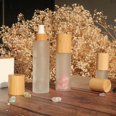 China Eco-friendly Recyclable Custom Frosted Glass Bottle Mist Logo Spray Lid Cosmetic Bamboo Perfume Bottle for sale