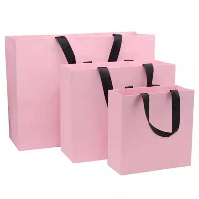 China Recyclable Famous Style Luxury Logo Printed Washable Paper Cosmetic Bag for sale