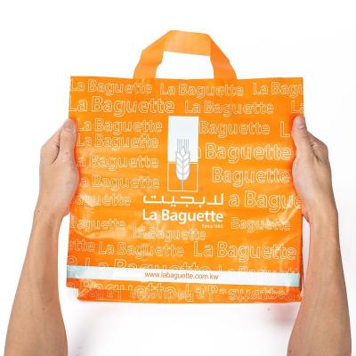 China Eco - Friendly Wholesale Biodegradable Clear Plastic Soft Loop Handle Shopping Bag for sale